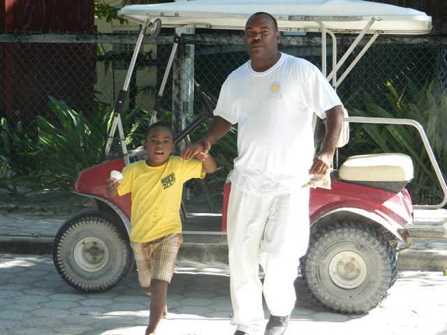 Kenrick from San Pedro Town Council bringing his son Josh to make a donation for his birthday cupcake kenrick brackett san pedro town council